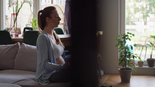 Pregnant woman meditate at home. Shot with RED helium camera in 8K