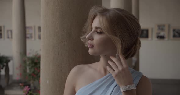 young woman in a festive outfit demonstrates precious jewelry