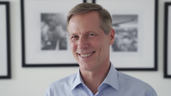 Smiling Middle Aged 50s Man Looking at Camera at Home Headshot Portrait