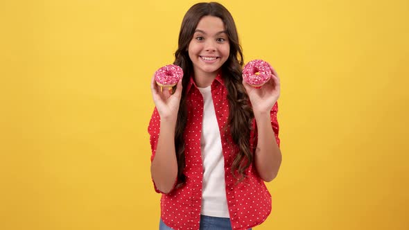 Happy Amazed Child Having Fun with Doughnut on Yellow Background Yummy