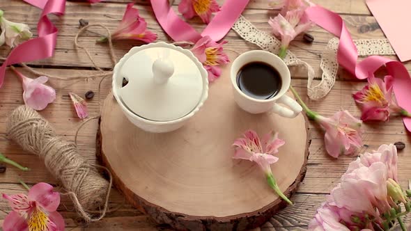 Сoffee cup and flowers on a wooden table zoom in