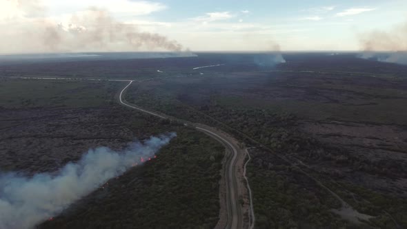 Aerial view of a wildfire burning short vegetation, Cambodia.