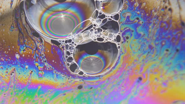 Abstract Liquid Light Forms Colorful Fluid Flow Around Big Bubbles