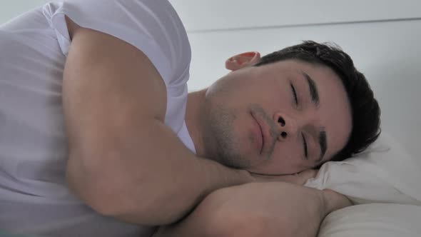 Young Man Sleeping in Bed