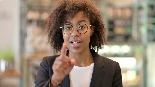 African Businesswoman with Pointing Finger and Inviting
