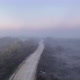 Aerial Top View of Sky Road Over Top of a Flat Ground with Fog and Green Jungle - VideoHive Item for Sale