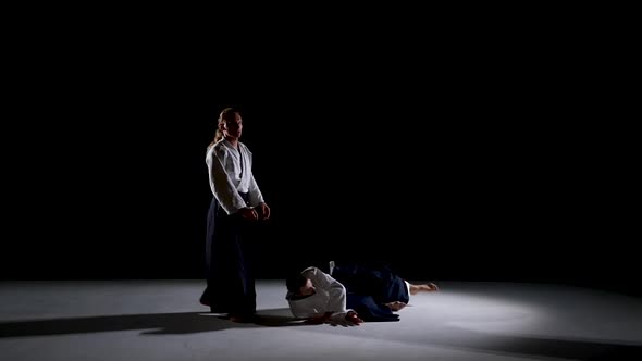 Two Aikido Masters Participants of the Training in Special Clothes of Aikido Hakama Work Out the