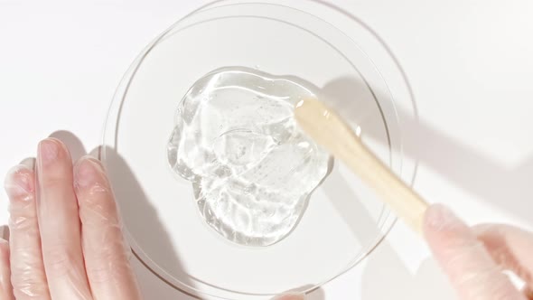 Transparent Cosmetic Gel Fluid in a Glass Bowl of Petri