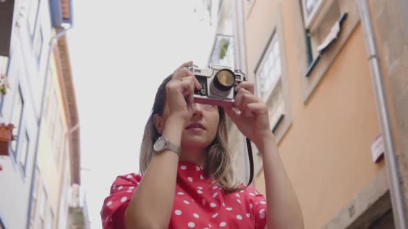Woman Photographer Is Taking a Photo on Vintage Camera