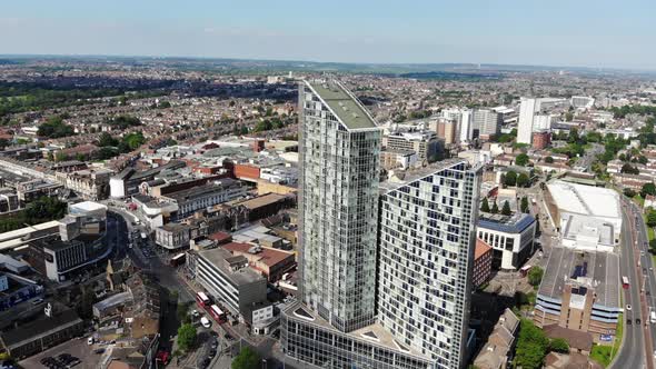 Aerial view of the two tall buildings in Ilford, London and red buses on the road on a sunny day