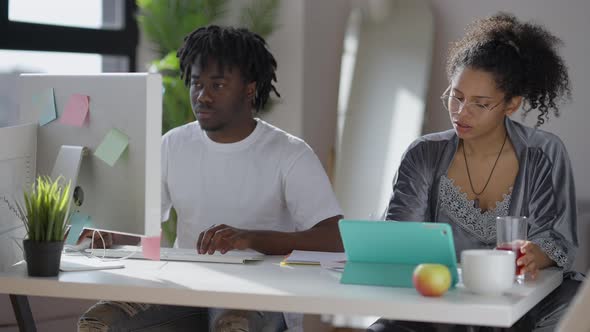 Busy Young African American Couple Working Online in the Morning in Home Office