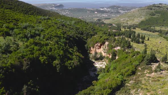 Erosion canyon in mountain forest landscape at Llogara National Park, Albanian Ionian Sea Coast. aer