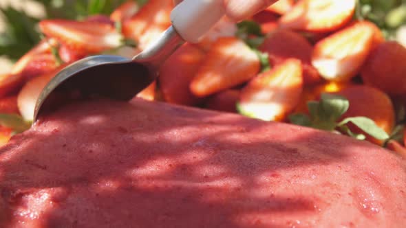 Closeup of the Special Icecream Spoon Scooping a Fresh Strawberry Ice Cream