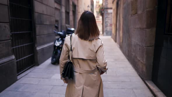 Unrecognizable Stranger Woman Walking Alone in Empty Narrow Street