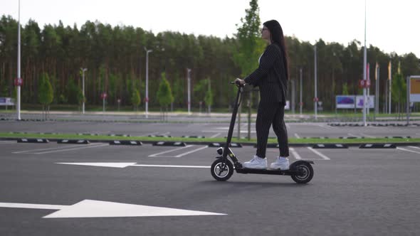 Epic Business Woman Riding Electric Scooter at Parking Lot