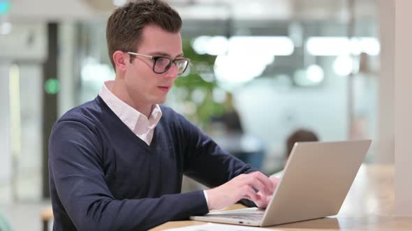 Thumbs Up By Positive Young Businessman Working 