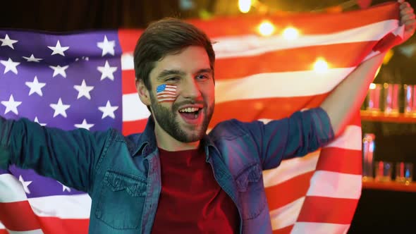 Happy American Soccer Fan Waving National Flag, Cheering for Favorite Team