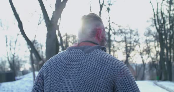 Wounded Soldier Walks and Looks Around on Winter Nature