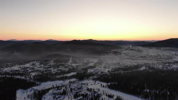 Picturesque Orange Sunset Behind Brown Hilltops in Highland