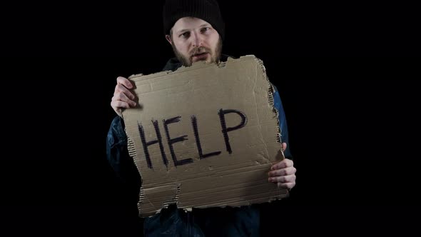 Homeless Holds Piece of Cardboard with Inscription Help