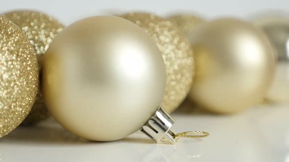 Reflective golden color Christmas bauble slow tilt 4K  footage