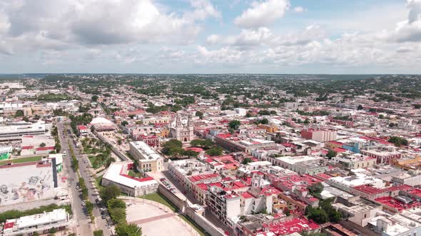 flying over the main plaza of the walled city of Campeche