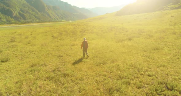 Flight Over Backpack Hiking Tourist Walking Across Green Mountain Field