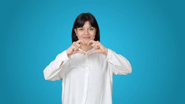Making heart with female hands.