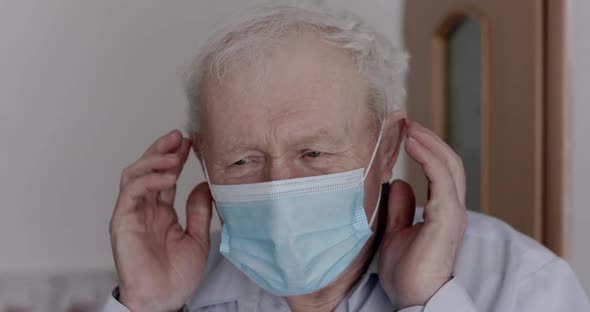 Portrait of Grandfather Wearing Medical Mask and Looking Confidently at Camera