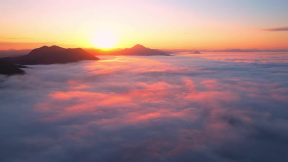 4K Aerial video Beautiful sunrise above dense clouds and fog in the morning