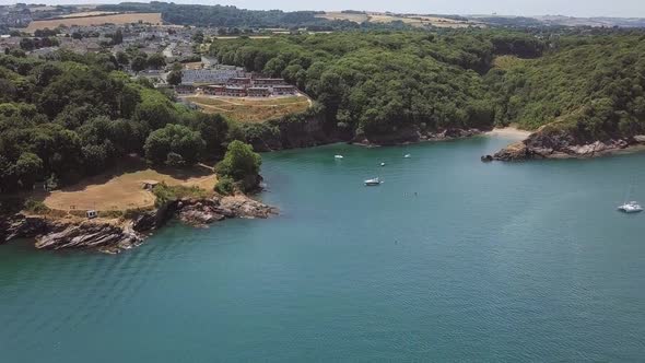 Aerial dolly in towards a beautiful small Bay on the English Channel.