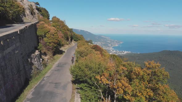 Aerial Shot: Group of Cyclists Riding Their Bicycles on Mountain Highway