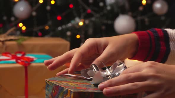 Close-up of Hands of Packing Gifts for Christmas