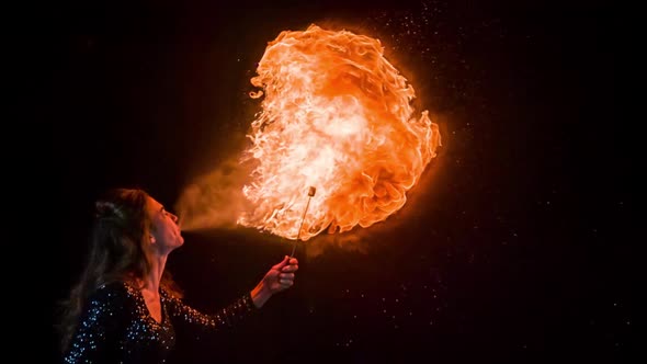 Woman breathing fire in slow motion