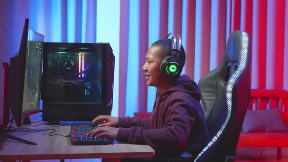 Male Child Using Headset Playing A Computer Game, Feeling Good During Playing Game
