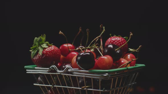 Red Fresh Strawberries and Cherries in a Little Trolley From a Super Layout