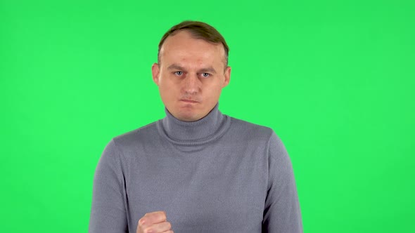 Portrait of Annoyed Man Gesturing in Stress Expressing Irritation and Anger. Green Screen