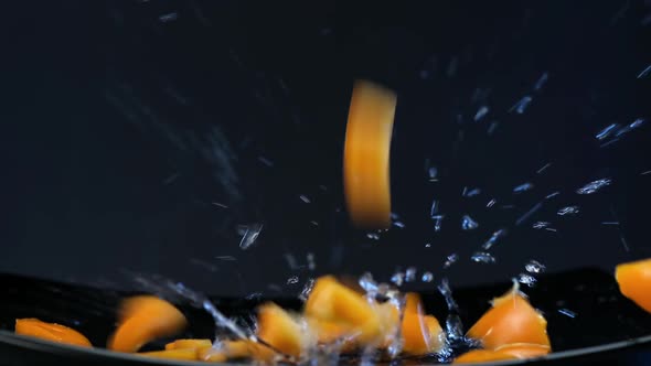 Delicious fresh sliced bell pepper falls on black plate