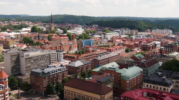 Downtown buildings of Swedish town Borås, aerial fly forward view