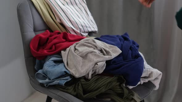 Cleaning Lady Removes Dirty Clothes From the Chair