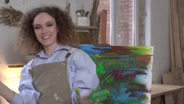 Joyful Happy Modern Woman Artist on the Background of an Abstraction Handdrawn Painting