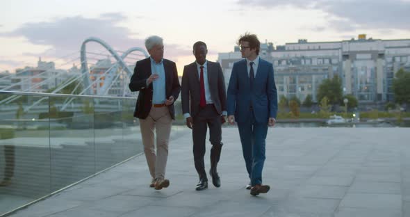 Full Length View of Three Diverse Businessman Communicating Walking Outdoors
