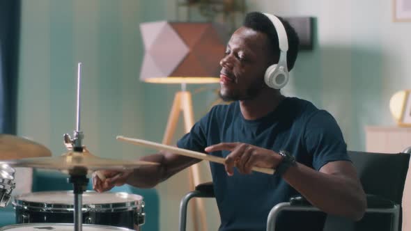 Handicapped African American Man Learning to Play Drums