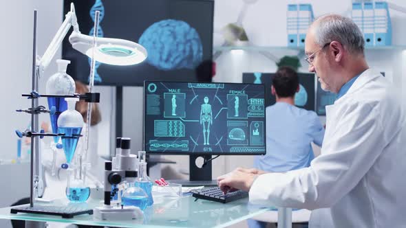 Mature Researcher Typing on Computer Keyborad alt