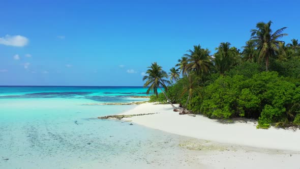 Aerial drone shot nature of idyllic sea view beach break by blue green water with white sandy backgr