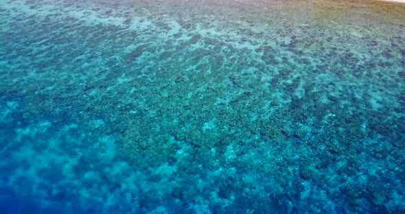 Luxury overhead clean view of a paradise sunny white sand beach and blue ocean background