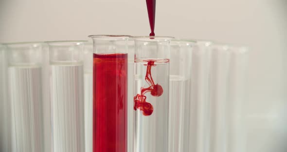 Blood Drops Into The Test Tubes