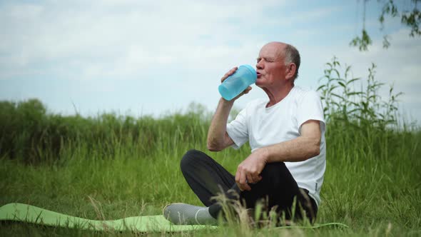 Lifestyle, Healthy Elderly Man Drinks Clean Cool Water From Bottle for Sports Nutrition After