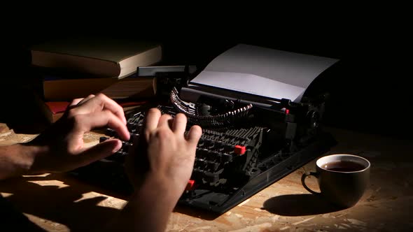 Man Typing a Typewriter at Night Creates a New Novel