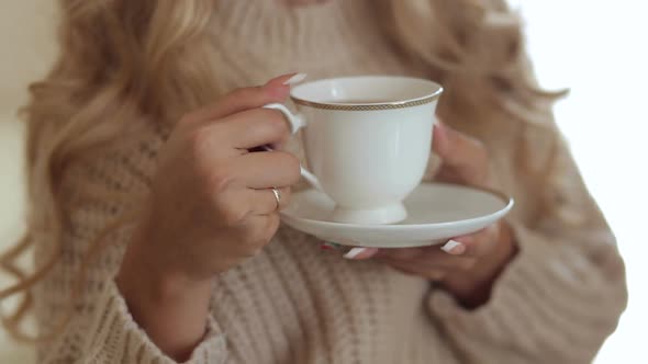 Closeup of a Girl Holding a Coffee Near Window